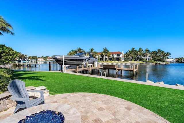 dock area with a lawn and a water view