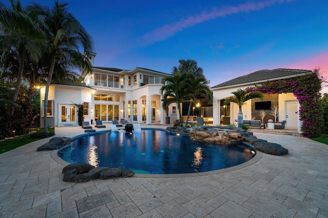 view of swimming pool featuring a patio area and french doors