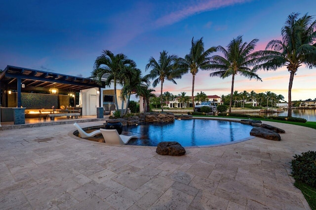 pool at dusk with a pergola, a water view, and a patio