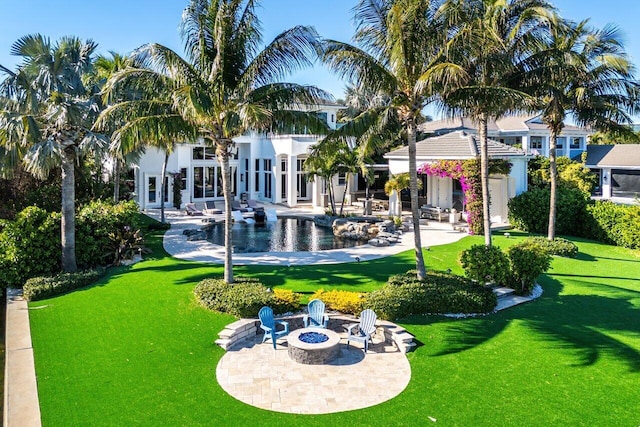 exterior space with a lawn, a patio area, a swimming pool, and a fire pit