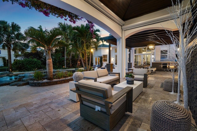 patio terrace at dusk featuring outdoor lounge area