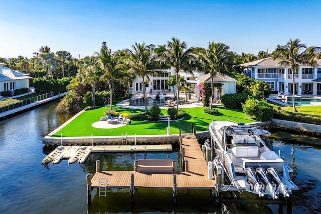 dock area with a yard and a water view