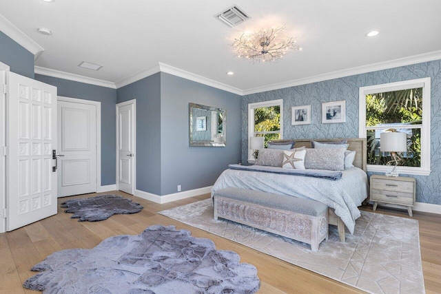 bedroom with light hardwood / wood-style floors and ornamental molding