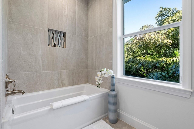 bathroom with a bath and a wealth of natural light