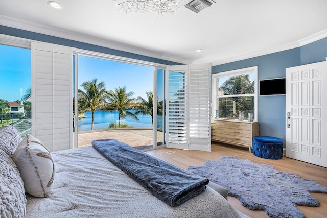 bedroom with access to exterior, wood-type flooring, and ornamental molding