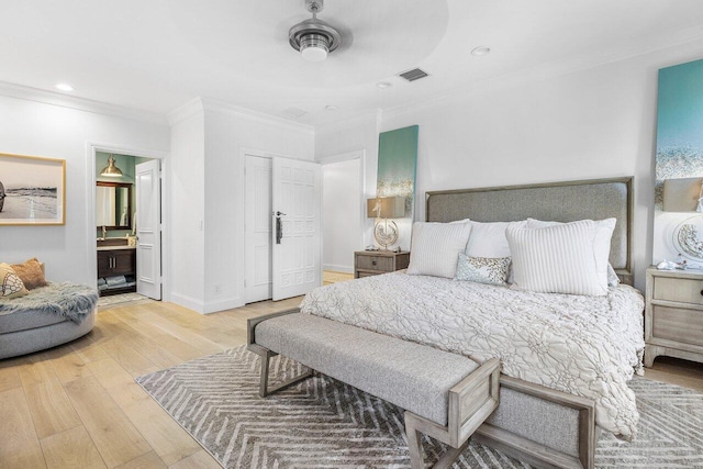 bedroom with connected bathroom, ceiling fan, light hardwood / wood-style flooring, and crown molding