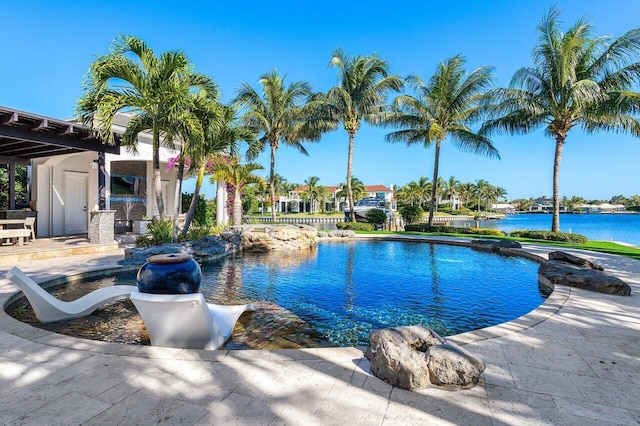 view of pool with a patio area and a water view