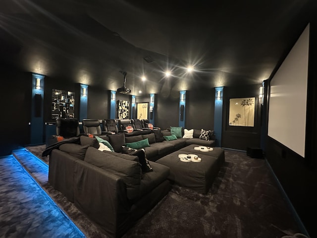 cinema room with dark carpet and ornate columns