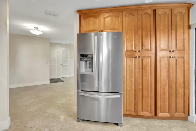 kitchen with light tile patterned floors and stainless steel refrigerator with ice dispenser