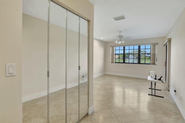 hallway featuring light tile patterned flooring