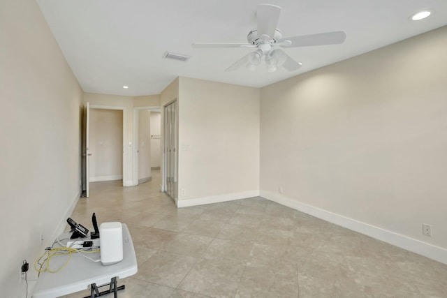 spare room featuring ceiling fan and light tile patterned floors