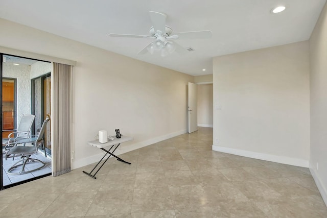 tiled spare room with ceiling fan