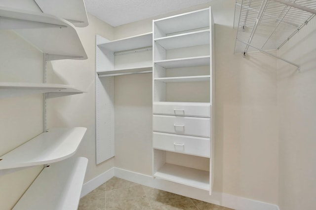 walk in closet featuring light tile patterned floors