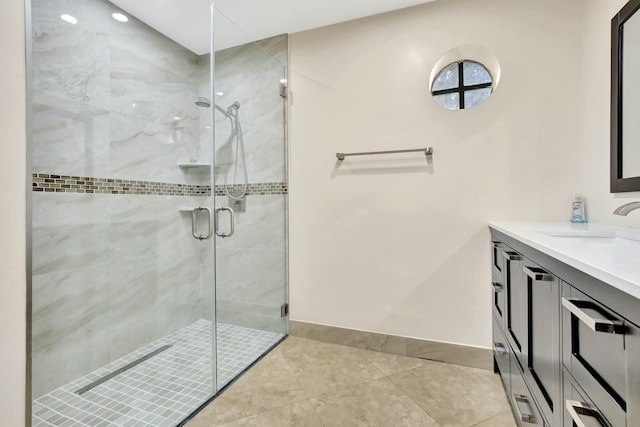 bathroom featuring tile patterned flooring, vanity, and a shower with door