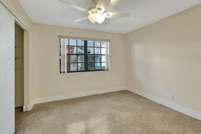 tiled empty room with ceiling fan