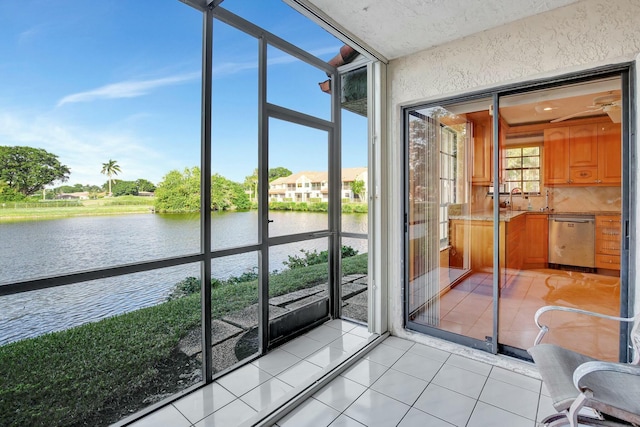 sunroom / solarium featuring a water view