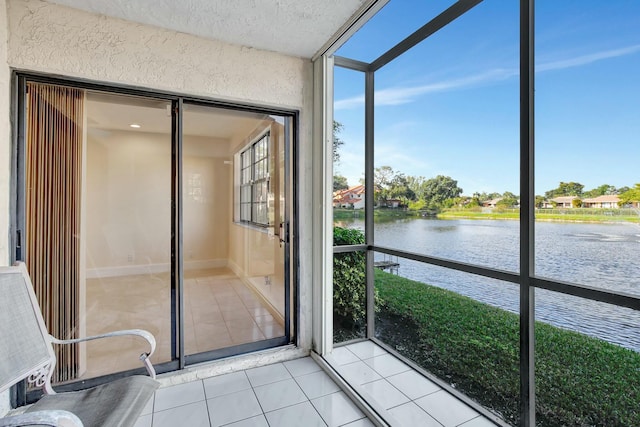 unfurnished sunroom featuring a water view