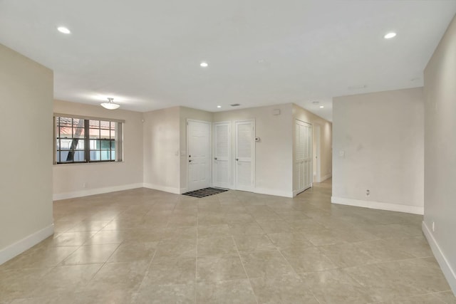 unfurnished room featuring light tile patterned floors