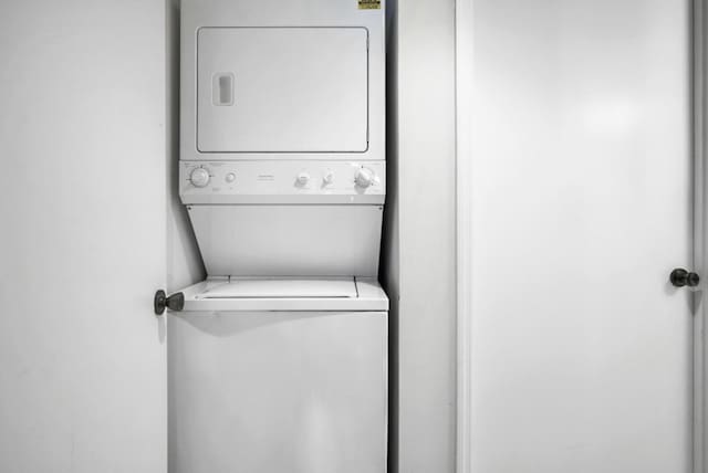 laundry area featuring stacked washer / dryer