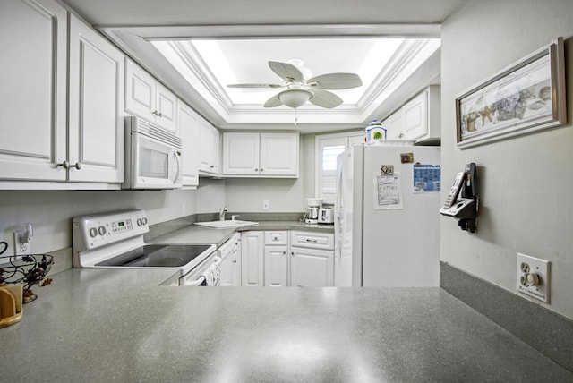 kitchen with ceiling fan, crown molding, white appliances, a tray ceiling, and white cabinets