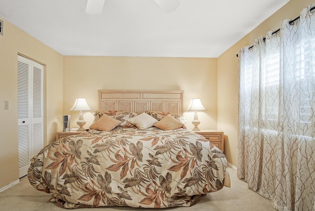 bedroom featuring light carpet, a closet, and ceiling fan