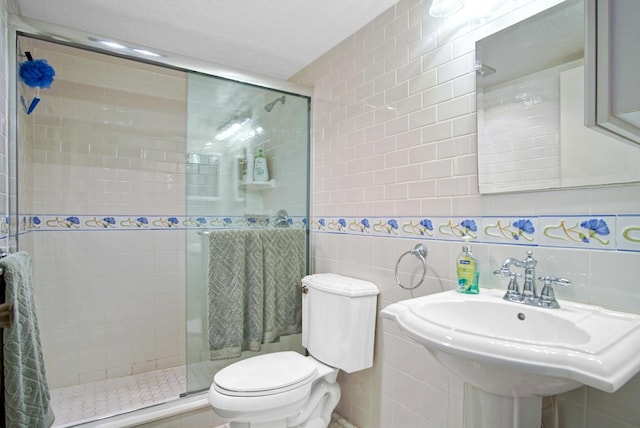 bathroom with sink, tile walls, and walk in shower