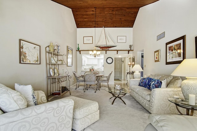 carpeted living room with wooden ceiling, high vaulted ceiling, and a chandelier