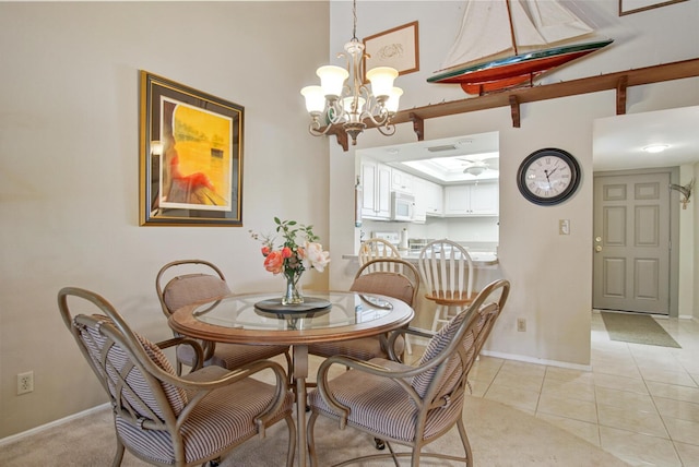 tiled dining room featuring a notable chandelier