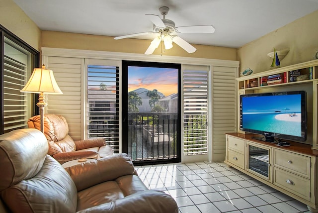 living room with ceiling fan and light tile patterned floors