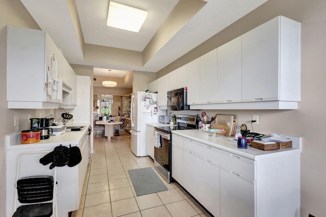 kitchen featuring white cabinetry, sink, white refrigerator, stainless steel electric range, and light tile patterned floors