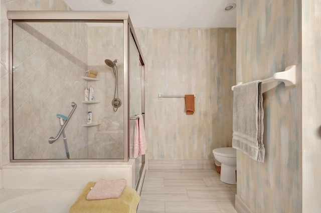 bathroom featuring toilet and an enclosed shower