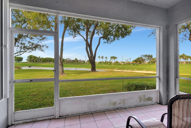 sunroom / solarium featuring a healthy amount of sunlight and a water view