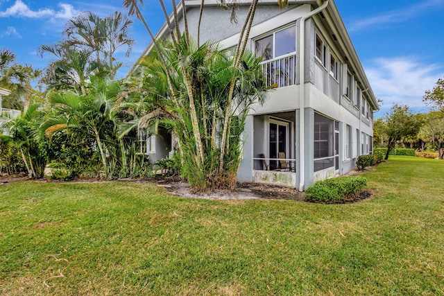 view of property exterior featuring a lawn