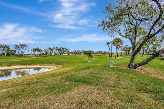 view of property's community featuring a lawn and a water view