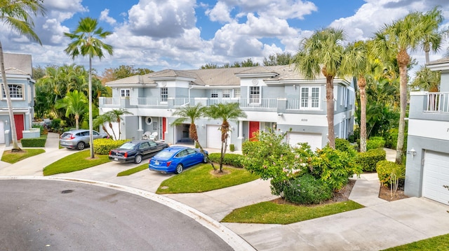 multi unit property featuring a garage and a balcony