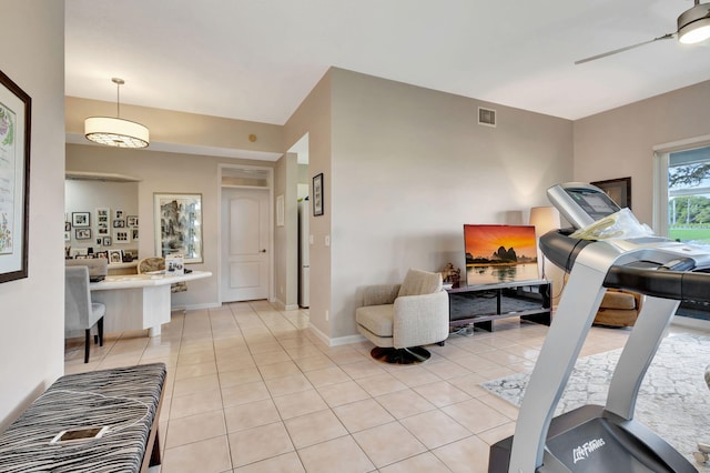 workout room featuring ceiling fan and light tile patterned floors