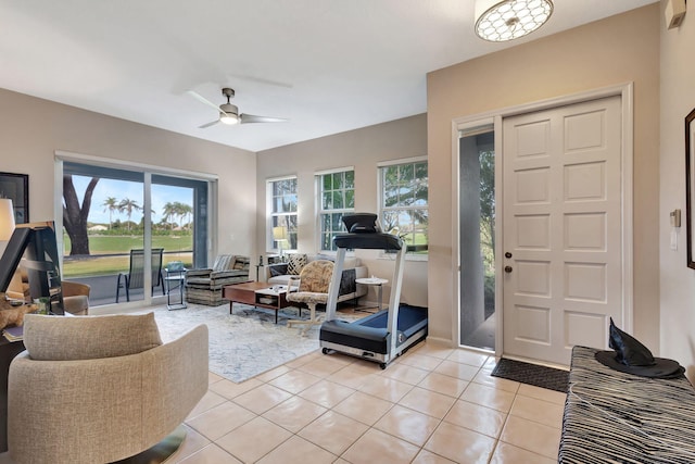 foyer entrance with ceiling fan, plenty of natural light, and light tile patterned flooring