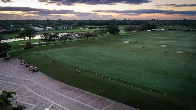 aerial view at dusk featuring a water view