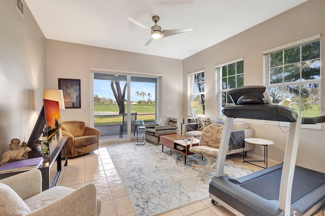 interior space with ceiling fan, plenty of natural light, and light tile patterned flooring