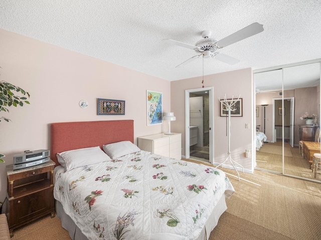 carpeted bedroom featuring ceiling fan, a closet, and a textured ceiling