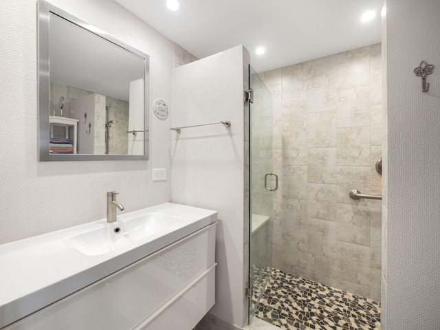 bathroom featuring vanity and a shower with shower door