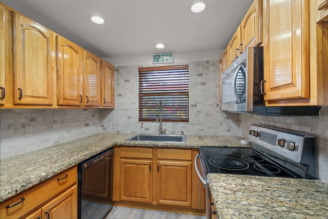 kitchen with black dishwasher, backsplash, range with electric stovetop, and sink