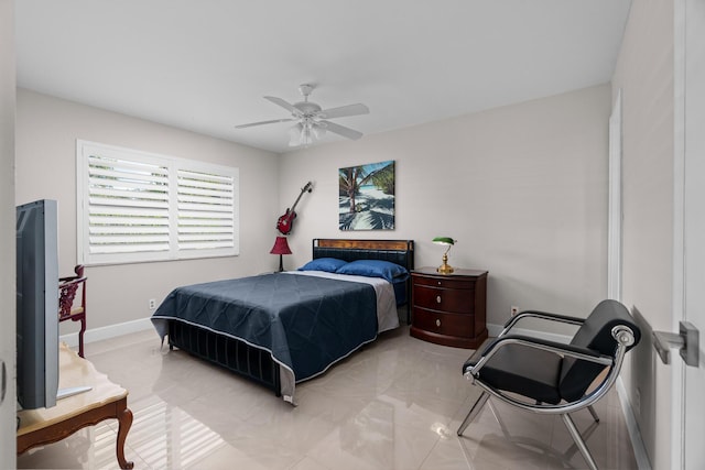 tiled bedroom featuring ceiling fan