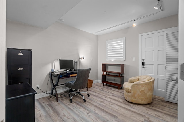 office area featuring light hardwood / wood-style floors and rail lighting