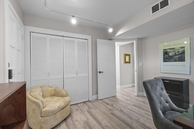 office featuring light hardwood / wood-style flooring and track lighting