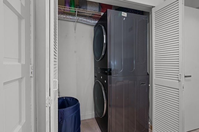 laundry area with stacked washer and dryer