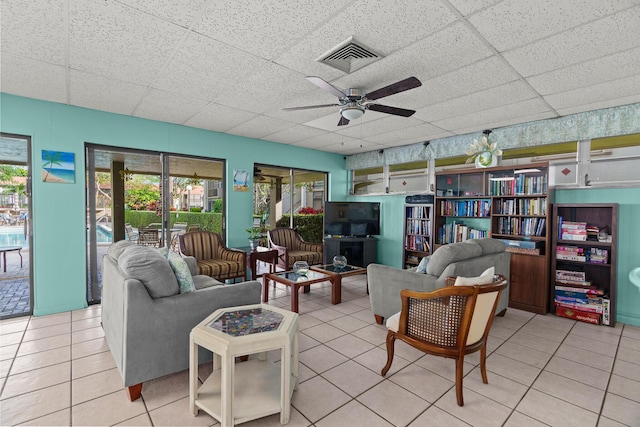 living room with ceiling fan and light tile patterned floors