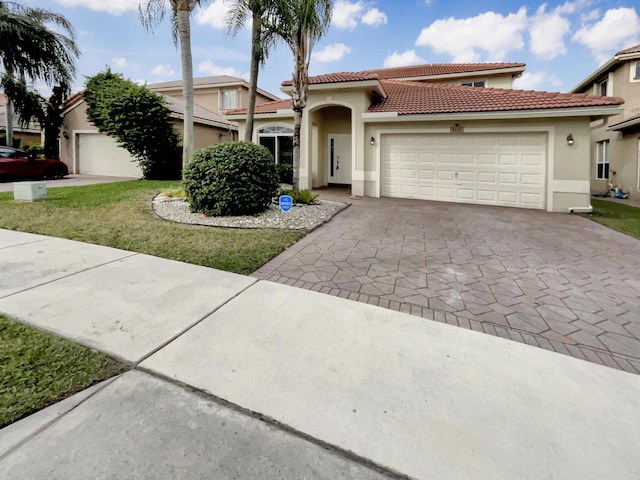 view of front of property with a front lawn and a garage