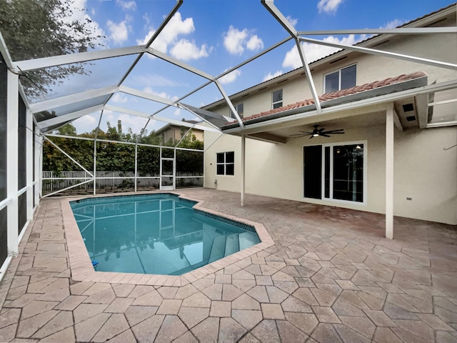 view of pool with ceiling fan, a lanai, and a patio