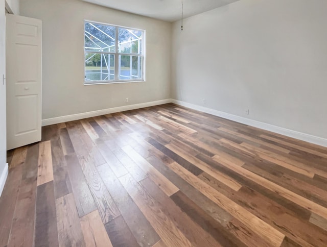 empty room featuring dark wood-type flooring